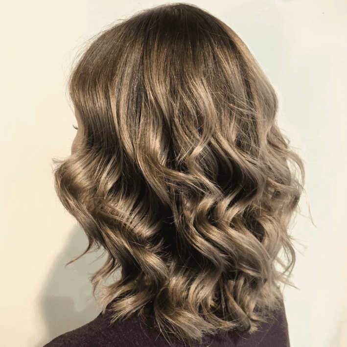 Get Smart Hair back of woman's head with medium length light brown wavy hair
