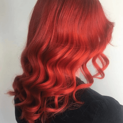 Get Smart Hair back of woman's head with medium length wavy red hair